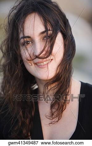 Stock Photo - Portrait of a mid adult woman smiling. Fotosearch