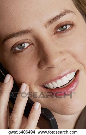 Portrait of a mid adult woman talking on a mobile phone View Large Photo Image Picture - Portrait of a mid adult woman talking on a mobile phone. Fotosearch