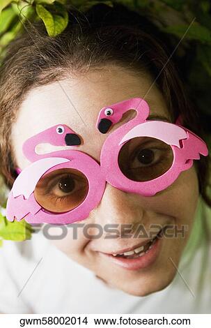 Portrait of a mid adult woman wearing sunglasses View Large Photo Image Picture - Portrait of a mid adult woman wearing sunglasses. Fotosearch