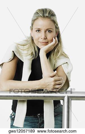 Portrait of a mid adult woman with her hand on her chin View Large Photo Image Stock Photo - Portrait of a mid adult woman with her hand on her chin. Fotosearch