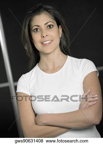 Portrait of a mid adult woman with her arms crossed smiling View Large Photo Image Stock Photo - Portrait of a mid adult woman with her arms crossed smiling. Fotosearch
