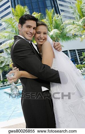 Portrait of a newlywed couple embracing each other View Large Photo Image Stock Photography - Portrait of a newlywed couple embracing each other. Fotosearch