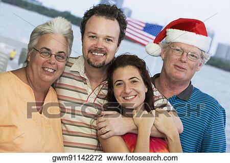 Portrait of a senior couple smiling with their family View Large Photo Image Stock Image - Portrait of a senior couple smiling with their family. Fotosearch