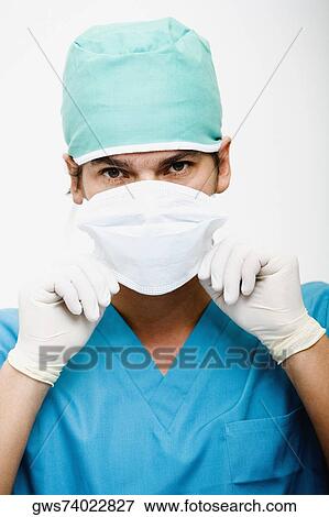 Portrait of a surgeon adjusting a surgical mask View Large Photo Image Stock Photo - Portrait of a surgeon adjusting a surgical mask. Fotosearch