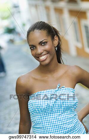 Portrait of a teenage girl smiling with her hand on her hip View Large Photo Image Picture - Portrait of a teenage girl smiling with her hand on her hip. Fotosearch