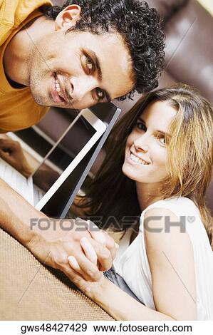 Portrait of a young couple lying down and holding hands View Large Photo Image Stock Photo - Portrait of a young couple lying down and holding hands. Fotosearch