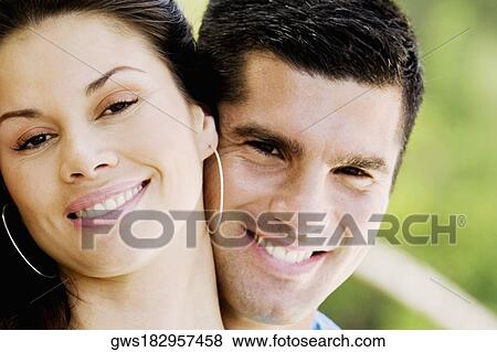 Portrait of a young couple smiling View Large Photo Image Stock Photo - Portrait of a young couple smiling. Fotosearch