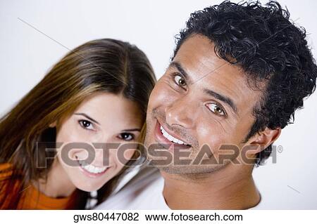 Portrait of a young man and a mid adult woman smiling View Large Photo Image Stock Image - Portrait of a young man and a mid adult woman smiling. Fotosearch