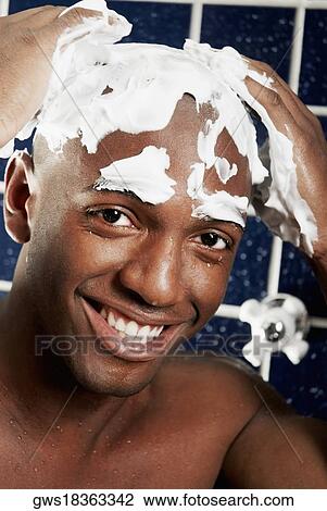 Portrait of a young man applying shaving cream on his head View Large Photo Image Stock Image - Portrait of a young man applying shaving cream on his head. Fotosearch
