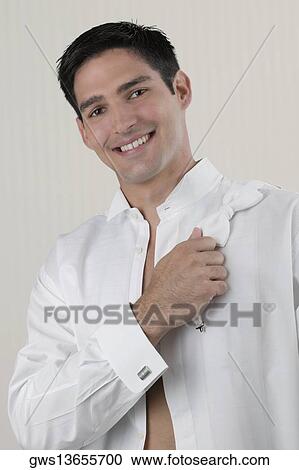 Portrait of a young man holding a bow tie on his shoulder View Large Photo Image Stock Image - Portrait of a young man holding a bow tie on his shoulder. Fotosearch