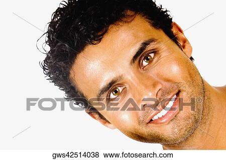 Stock Photo - Portrait of a young man holding a paint roller and smiling. Fotosearch