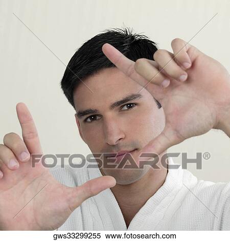 Stock Photography - Portrait of a young man making a framing gesture. Fotosearch