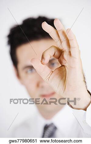 Portrait of a young man pretending to wear glasses View Large Photo Image Stock Image - Portrait of a young man pretending to wear glasses. Fotosearch