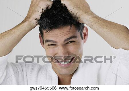 Portrait of a young man pulling his hair View Large Photo Image Stock Photograph - Portrait of a young man pulling his hair. Fotosearch