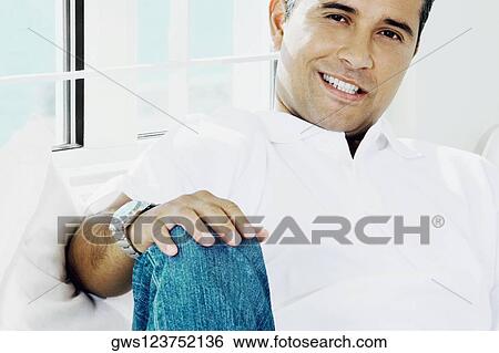 Portrait of a young man reclining View Large Photo Image Stock Photograph - Portrait of a young man reclining. Fotosearch