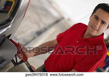 Portrait of a young man refueling a car View Large Photo Image Stock Photo - Portrait of a young man refueling a car. Fotosearch