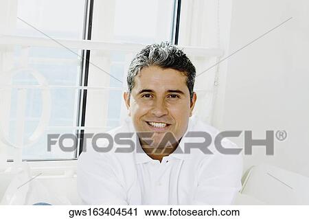 Portrait of a young man smiling View Large Photo Image Stock Image - Portrait of a young man smiling. Fotosearch