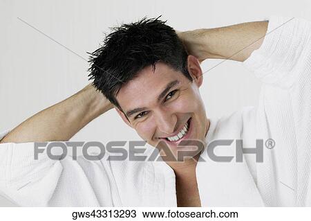 Portrait of a young man smiling with his hands behind his head View Large Photo Image Stock Image - Portrait of a young man smiling with his hands behind his head. Fotosearch