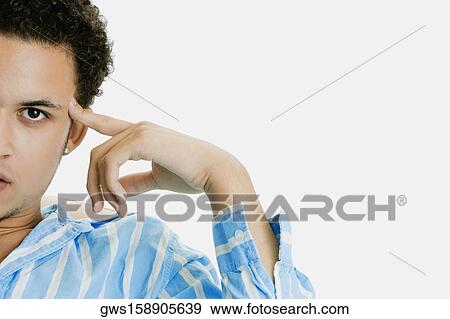 Stock Photo - Portrait of a young man thinking. Fotosearch