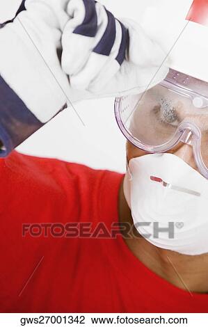 Portrait of a young man wearing a hardhat with a pollution mask and a protective eyewear View Large Photo Image Stock Image - Portrait of a young man wearing a hardhat with a pollution mask and a protective eyewear. Fotosearch