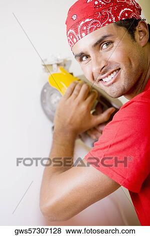 Portrait of a young man working with a circular saw View Large Photo Image Stock Photo - Portrait of a young man working with a circular saw. Fotosearch