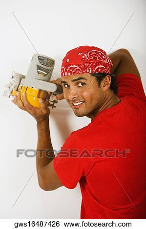 Portrait of a young man working with a circular saw View Large Photo Image Stock Photograph - Portrait of a young man working with a circular saw. Fotosearch