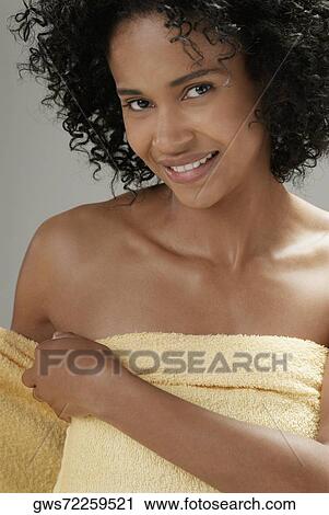 Portrait of a young woman adjusting a towel View Large Photo Image Stock Image - Portrait of a young woman adjusting a towel. Fotosearch