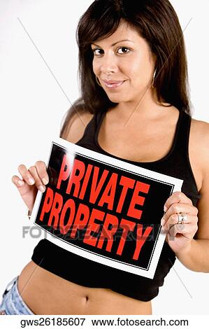 Portrait of a young woman holding a Private Property sign View Large Photo Image Stock Photo - Portrait of a young woman holding a Private Property sign. Fotosearch