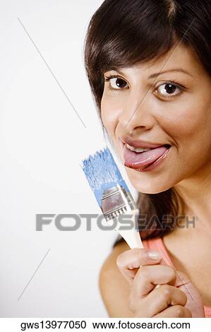 Portrait of a young woman licking a paintbrush View Large Photo Image Stock Image - Portrait of a young woman licking a paintbrush. Fotosearch