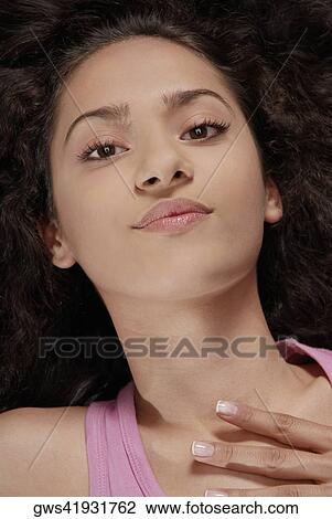 Portrait of a young woman lying down View Large Photo Image Stock Image - Portrait of a young woman lying down. Fotosearch