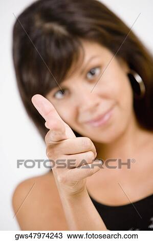 Portrait of a young woman pointing forward View Large Photo Image Stock Image - Portrait of a young woman pointing forward. Fotosearch