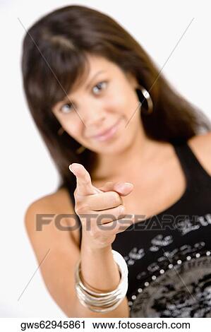 Stock Image - Portrait of a young woman pointing forward. Fotosearch