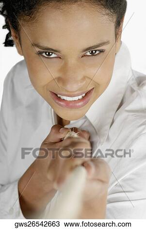 Portrait of a young woman pulling a rope and smiling View Large Photo Image Stock Image - Portrait of a young woman pulling a rope and smiling. Fotosearch