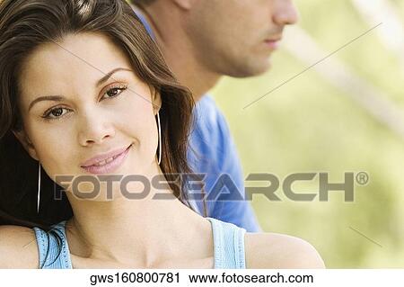 Stock Image - Portrait of a young woman smiling. Fotosearch
