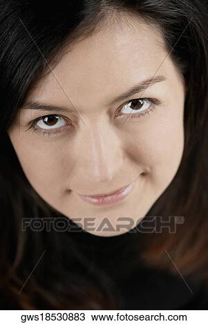 Stock Image - Portrait of a young woman smiling. Fotosearch