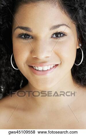 Portrait of a young woman smiling View Large Photo Image Stock Photo - Portrait of a young woman smiling. Fotosearch