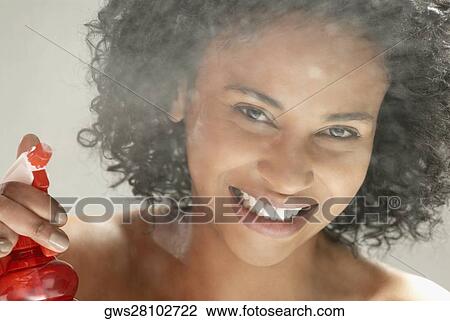 Portrait of a young woman spraying water View Large Photo Image Stock Image - Portrait of a young woman spraying water. Fotosearch