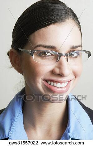 Portrait of a young woman wearing a pair of eyeglasses View Large Photo Image Stock Image - Portrait of a young woman wearing a pair of eyeglasses. Fotosearch