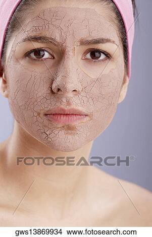 Portrait of a young woman with a facial mask View Large Photo Image Picture - Portrait of a young woman with a facial mask. Fotosearch