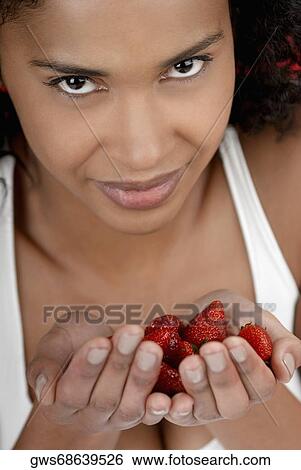 Portrait of a young woman with strawberries in her hands View Large Photo Image Stock Photograph - Portrait of a young woman with strawberries in her hands. Fotosearch