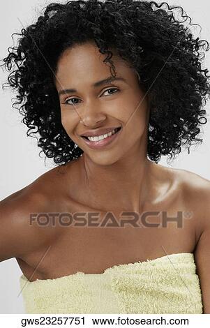 Portrait of a young woman wrapped in a towel and smiling View Large Photo Image Stock Image - Portrait of a young woman wrapped in a towel and smiling. Fotosearch