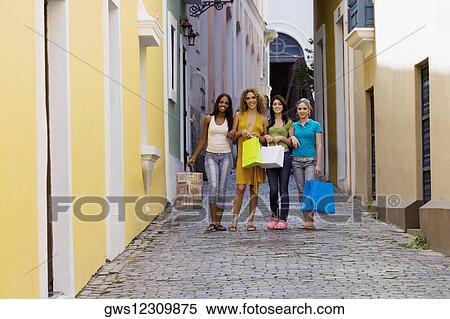 Portrait of four teenage girls standing in an alley and holding shopping bags View Large Photo Image Stock Photography - Portrait of four teenage girls standing in an alley and holding shopping bags. Fotosearch