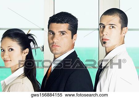 Portrait of two businessmen and a businesswoman standing View Large Photo Image Stock Photography - Portrait of two businessmen and a businesswoman standing. Fotosearch