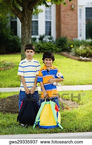 Stock Photo - Portrait of two schoolboys holding schoolbags. Fotosearch