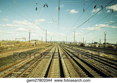 Picture - Power cables over railroad tracks. Fotosearch
