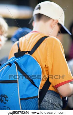 Rear view of a boy carrying a backpack, Rome, Italy View Large Photo Image Stock Photograph - Rear view of a boy carrying a backpack, Rome, Italy. Fotosearch