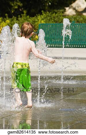 Rear view of a boy in a bath on a fountain View Large Photo Image Stock Photography - Rear view of a boy in a bath on a fountain. Fotosearch
