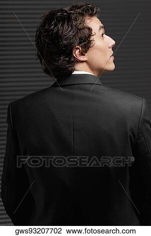 Rear view of a businessman looking up and thinking View Large Photo Image Stock Image - Rear view of a businessman looking up and thinking. Fotosearch