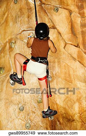 Rear view of a girl climbing a wall View Large Photo Image Stock Photo - Rear view of a girl climbing a wall. Fotosearch
