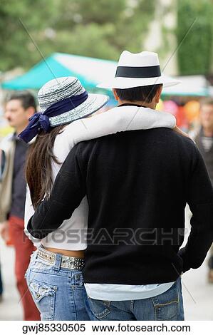 Rear view of a man and a woman with their arms around each other View Large Photo Image Stock Photography - Rear view of a man and a woman with their arms around each other. Fotosearch